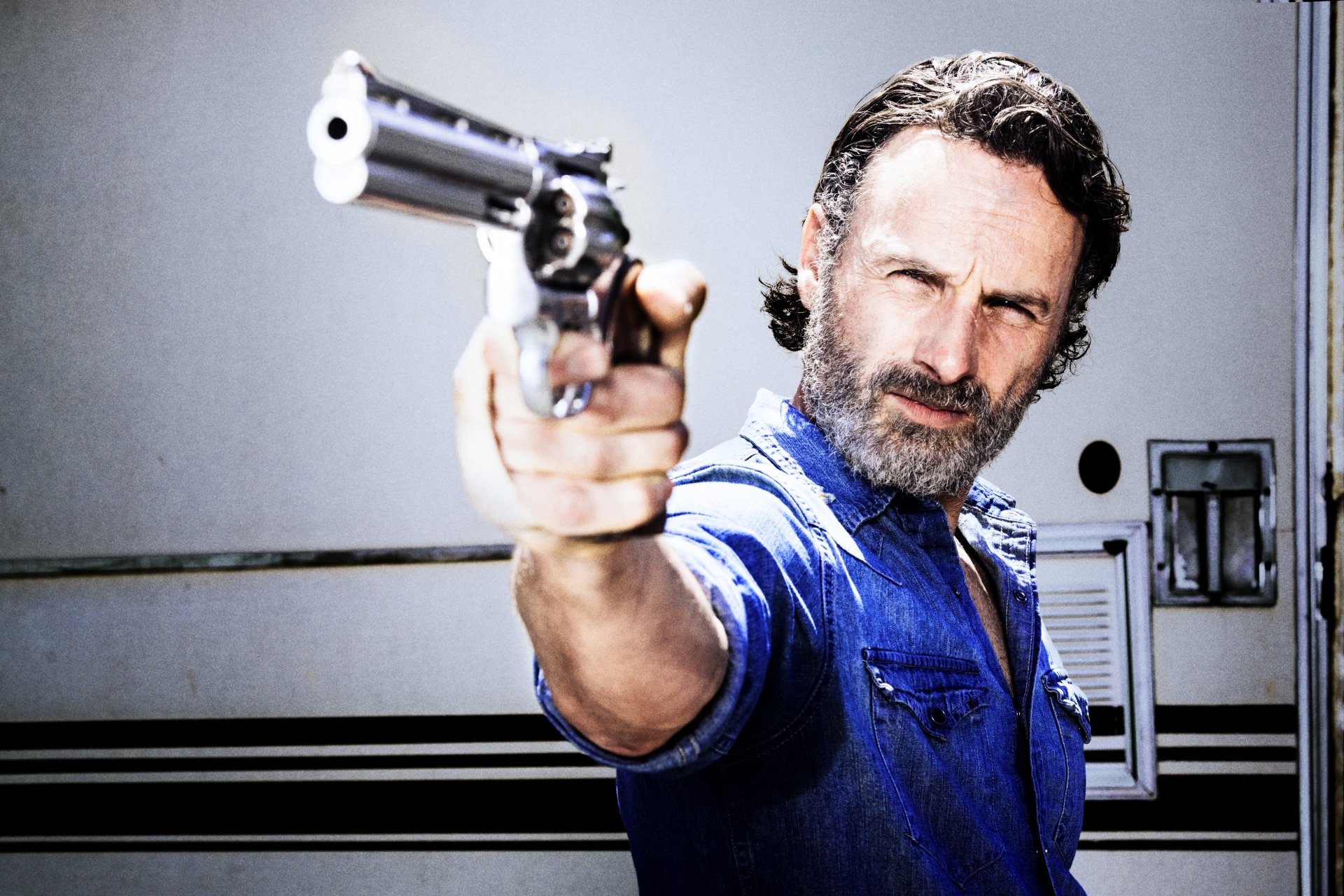 Andrew Lincoln as Rick Grimes from The Walking Dead aiming a revolver in a high-resolution 4K Ultra HD TV show desktop wallpaper.