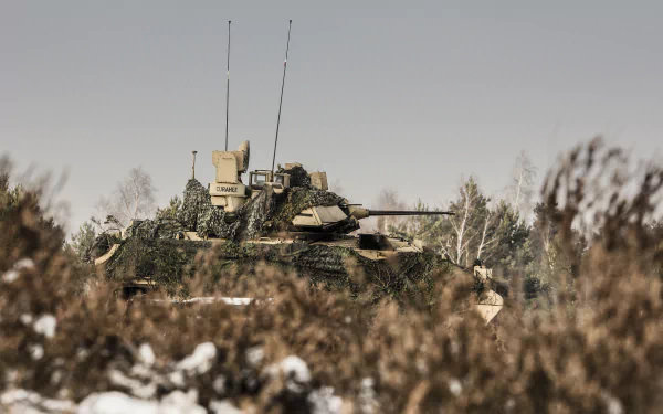 4K Ultra HD image of an M2 Bradley armored personnel carrier positioned in a snowy, wooded area, highlighting its military design and tactical features.