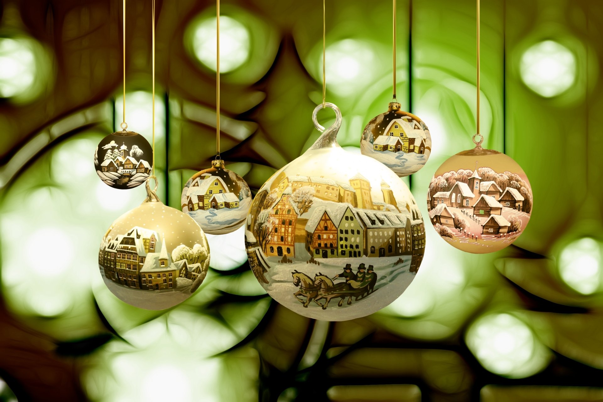 HD desktop wallpaper featuring shiny Christmas baubles decorated with festive holiday village scenes, softly glowing against a green bokeh background.