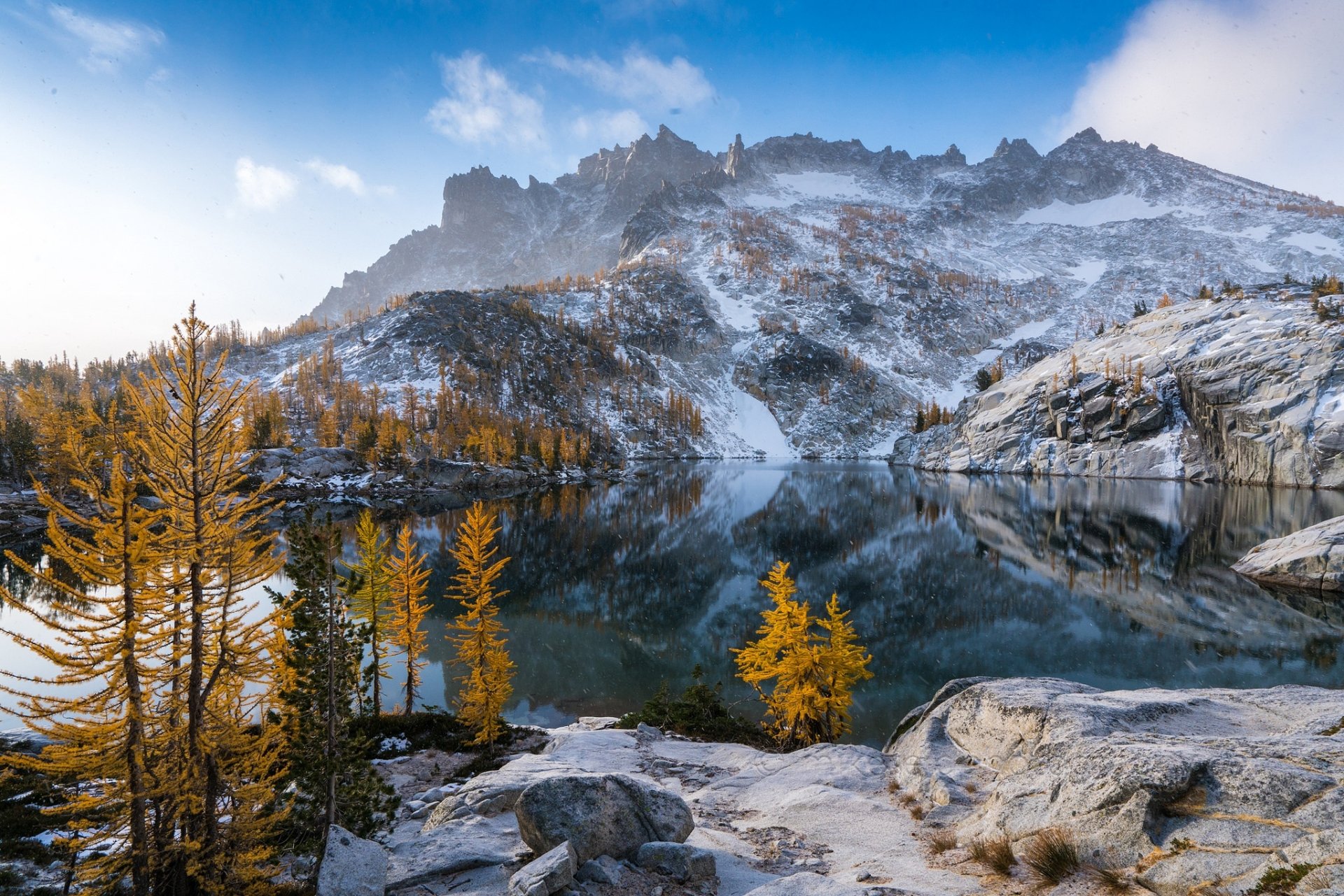 HD PC desktop wallpaper featuring a serene lake reflecting rugged mountains and autumn trees, capturing the beauty of nature in vivid detail.