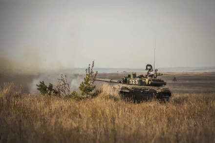 A T-90 military tank moves through a field, captured in 4K Ultra HD detail, set against a hazy, expansive landscape background.