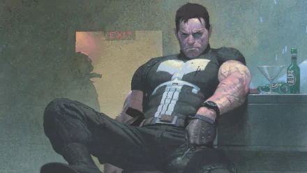 HD PC desktop wallpaper: comic Punisher — skull-emblazoned, battered vigilante slumped against a wall under an EXIT sign, brooding in dim, gritty light.