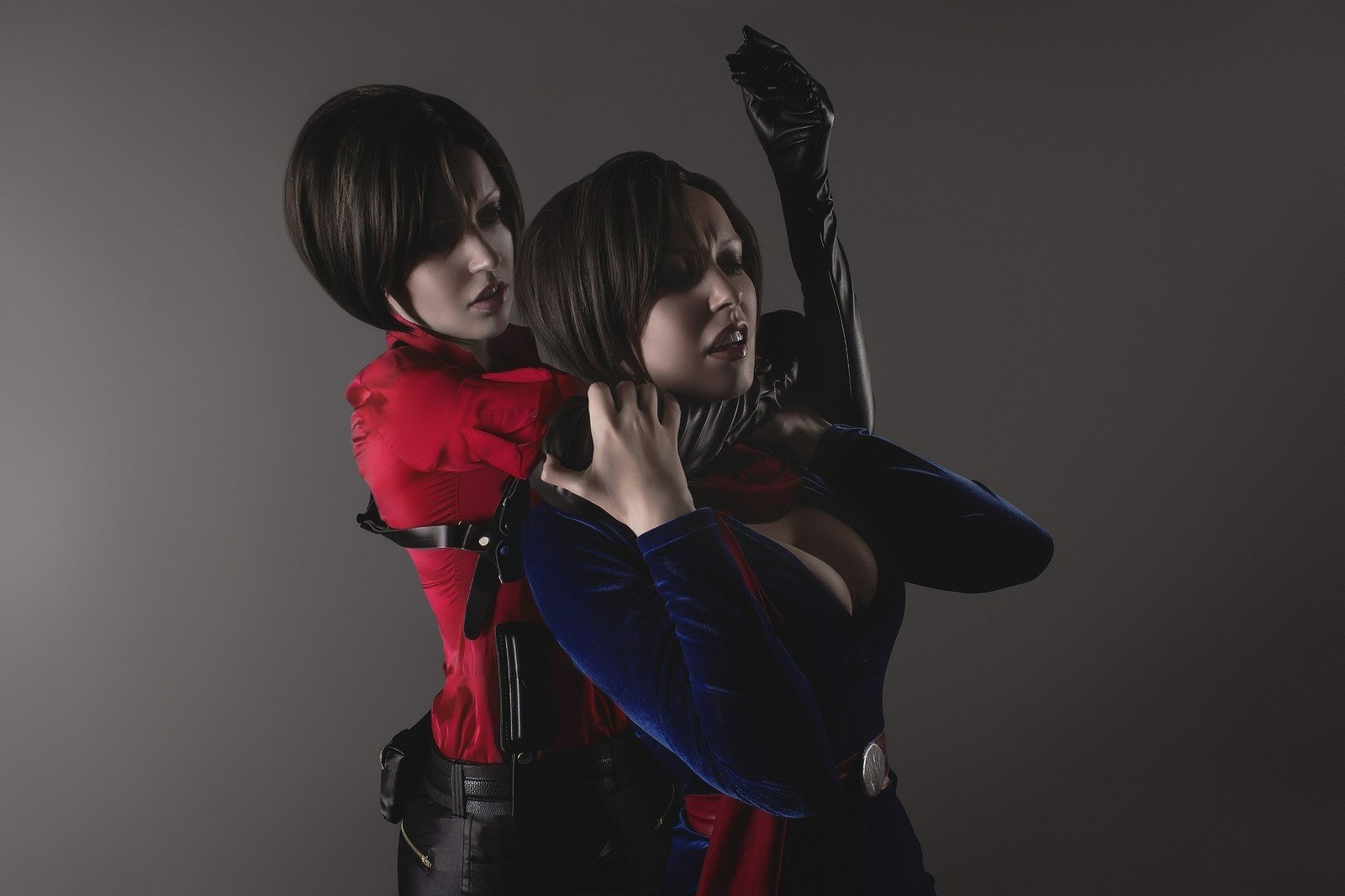 HD desktop wallpaper featuring a woman cosplaying as Ada Wong from the Resident Evil series, engaged in an intense, dramatic action scene against a gray background.