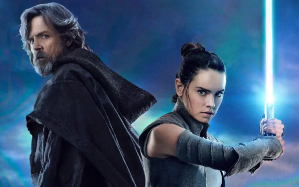 HD wallpaper featuring Daisy Ridley as Rey and Mark Hamill as Luke Skywalker from Star Wars: The Last Jedi, with Rey holding a glowing blue lightsaber against a dramatic background.