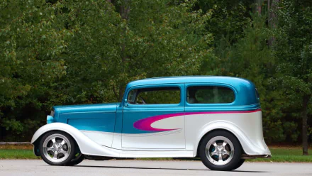 HD PC desktop wallpaper and background showing a vehicle — Chevrolet Sedan Street Rod: blue-and-white body with a pink swoosh, parked on pavement before a tree line.
