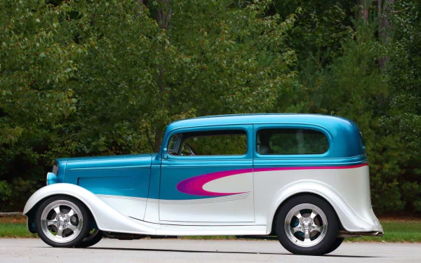 HD PC desktop wallpaper and background showing a vehicle — Chevrolet Sedan Street Rod: blue-and-white body with a pink swoosh, parked on pavement before a tree line.