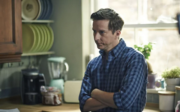HD desktop wallpaper featuring a contemplative man in a blue checkered shirt from The A Word.