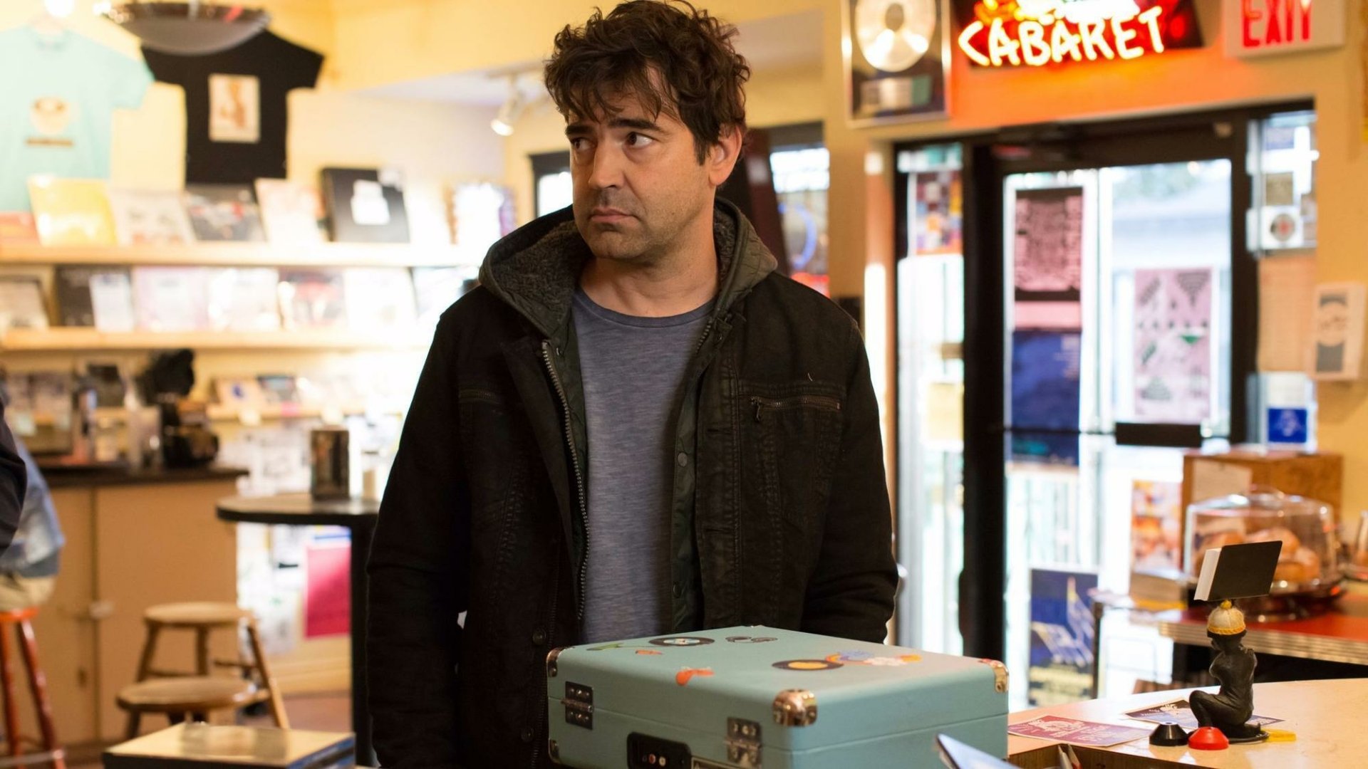 HD wallpaper featuring a scene from Loudermilk with a man standing in a store, portraying a character from the show.