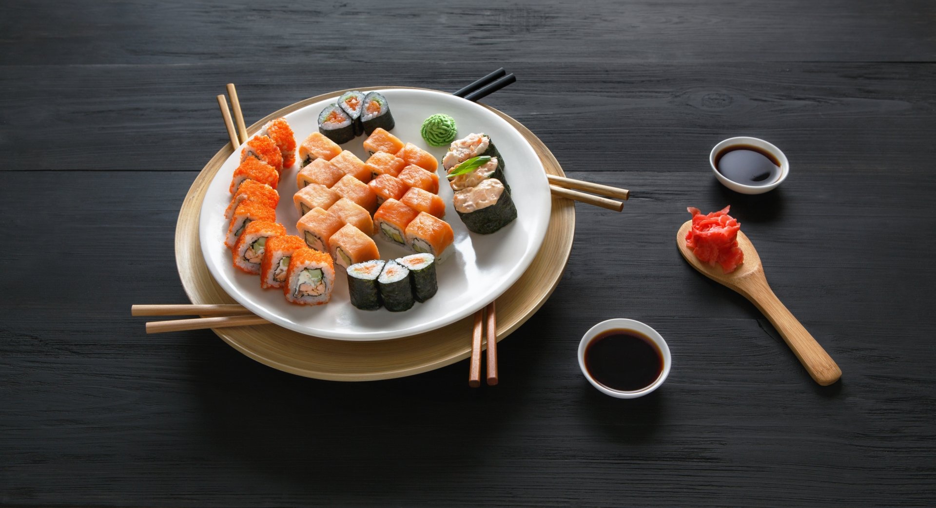 A vibrant still life of assorted sushi, including fish and rice, arranged on plates with soy sauce and pickled ginger, captured in 4K Ultra HD quality.
