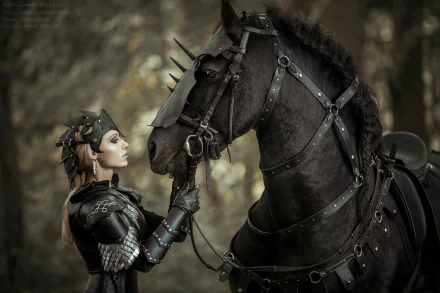 HD PC desktop wallpaper featuring a woman in detailed cosplay armor gently touching the face of a black horse wearing matching spiked armor.