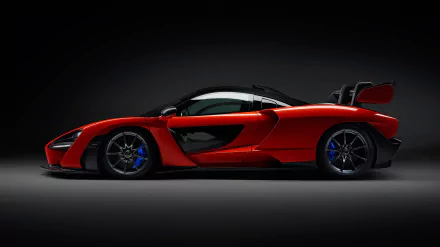 Side view of a red McLaren Senna supercar with black accents, showcased as a 4K Ultra HD desktop wallpaper and background.