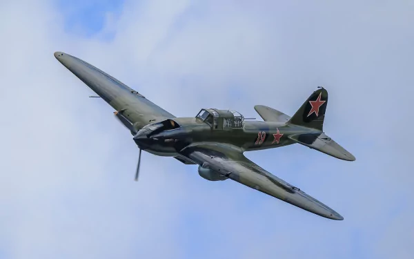 HD desktop wallpaper of an Ilyushin Il-2 military warplane flying against a clear sky, showcasing its classic aircraft design and markings.