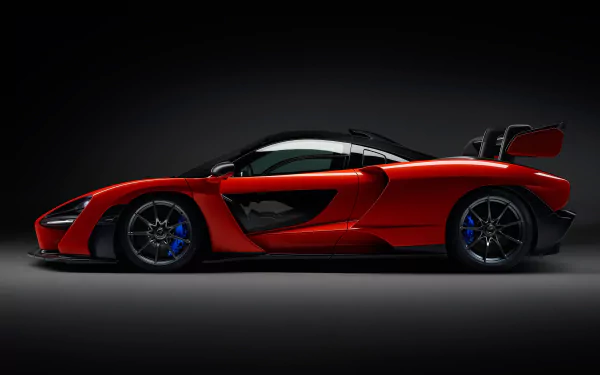 Side view of a red McLaren Senna supercar with black accents, showcased as a 4K Ultra HD desktop wallpaper and background.