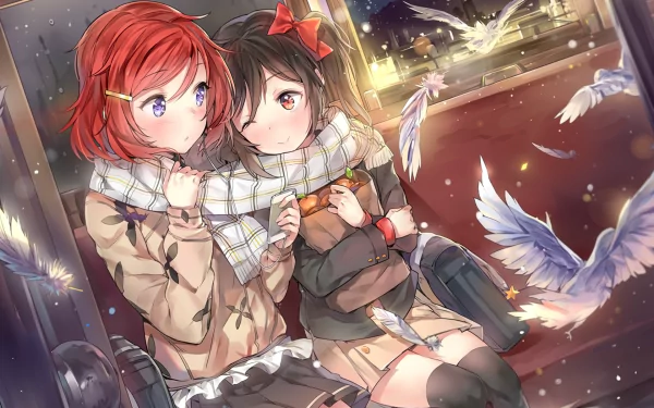 HD wallpaper featuring Maki Nishikino and Nico Yazawa from the anime Love Live! They are sitting together, sharing a scarf, with wintery scenery and white feathers floating around them.