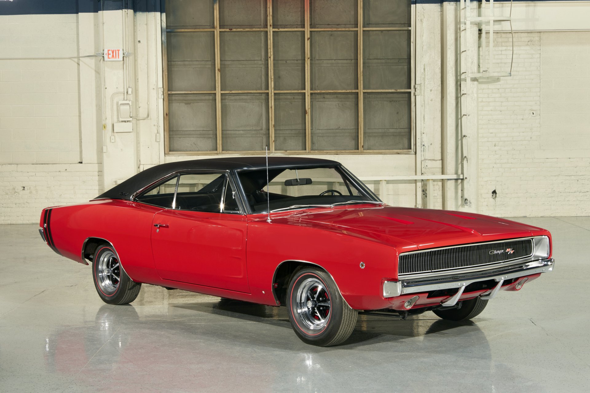 Red Dodge Charger RT muscle car parked in an industrial garage, shown as a 2K Quad HD PC desktop wallpaper and background.