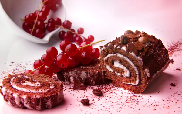 5K Ultra HD PC desktop wallpaper and background of a dessert chocolate roulade cake — food photography with cream swirl, clusters of red currants and crumbs on a pink backdrop.