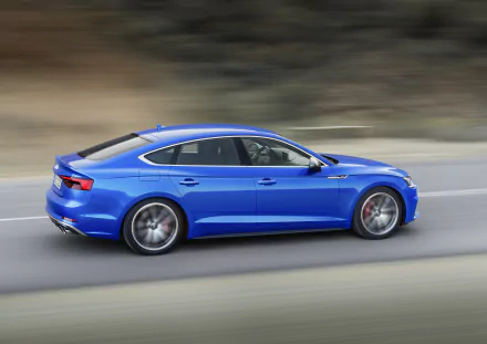Blue Audi A5 car speeding along a highway; a high-resolution 4K Ultra HD desktop wallpaper of a sleek Audi vehicle.