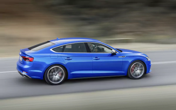 Blue Audi A5 car speeding along a highway; a high-resolution 4K Ultra HD desktop wallpaper of a sleek Audi vehicle.