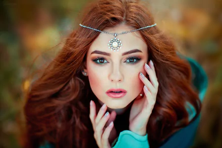 Close-up of a redhead woman with brown eyes and bold lipstick, wearing a jeweled headpiece, styled as an HD PC desktop wallpaper and background.