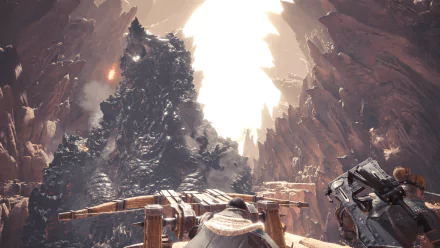 HD desktop wallpaper of Monster Hunter: World featuring a massive creature in a rocky, sunlit canyon backdrop, with detailed weaponry in the foreground.