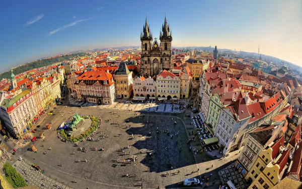 A stunning 4K Ultra HD view of Prague's historic city square, showcasing the iconic Gothic architecture under a clear sky in the Czech Republic.