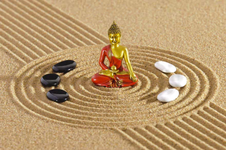 HD desktop wallpaper featuring a golden and red Buddha statue surrounded by black and white stones on raked sand, evoking a sense of zen and tranquility.