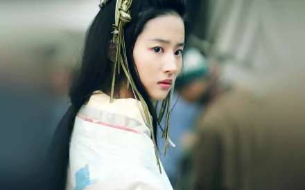 HD wallpaper featuring an Asian model with black, long hair and brown eyes, set against a blurred background.
