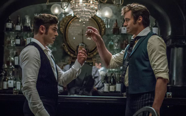 HD desktop wallpaper from The Greatest Showman featuring two characters toasting glasses in a dimly lit bar.