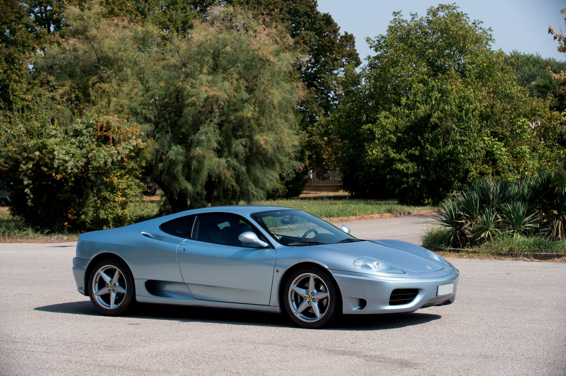 Silver Ferrari 360 Modena supercar parked outdoors, captured in high-definition for a striking PC desktop wallpaper background.