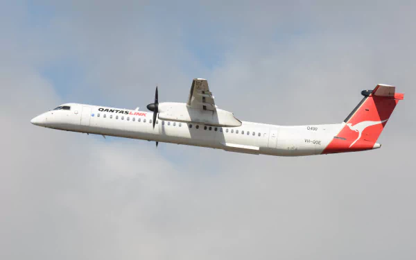 HD desktop wallpaper featuring a Bombardier Dash 8 De Havilland passenger plane flying against a cloudy sky background.