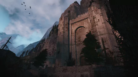 HD desktop wallpaper of Kaer Morhen from the video game The Witcher 3: Wild Hunt, showcasing the fortress against a moody sky and mountainous backdrop.