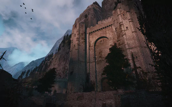 HD desktop wallpaper of Kaer Morhen from the video game The Witcher 3: Wild Hunt, showcasing the fortress against a moody sky and mountainous backdrop.