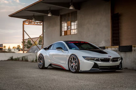 Silver BMW i8 supercar parked outside an industrial building, captured in stunning 4K Ultra HD for a dramatic PC desktop wallpaper background.
