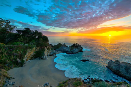 A breathtaking view of McWay Falls in Big Sur, California, at sunset. The serene beach and ocean meet the vibrant sky, creating a stunning HD desktop wallpaper and background of nature's beauty.