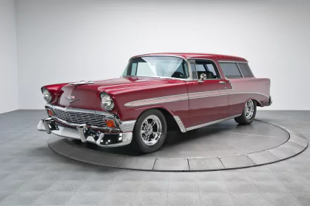 Red 1956 Chevrolet Bel Air Nomad station wagon on a studio turntable, classic Chevrolet vehicle — 2K Quad HD PC desktop wallpaper/background.