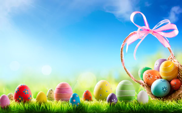 Colorful Easter eggs displayed on green grass under a bright blue sky, with a basket tied with a pink ribbon, captured in vivid 8K Ultra HD quality.