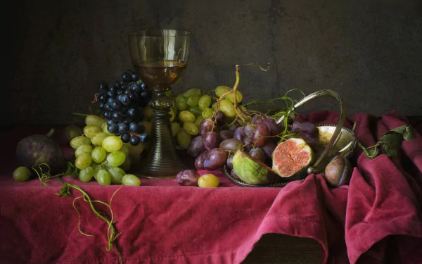 HD PC desktop wallpaper/background: still life of figs and assorted green, red and black grapes on a red cloth with a wine goblet, classic fruit food scene.