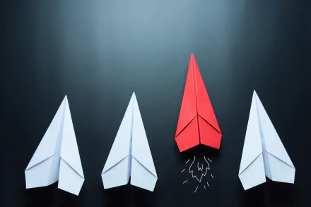HD desktop wallpaper featuring four paper airplanes made with origami, three white and one red, against a dark background.