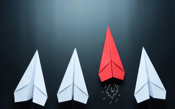 HD desktop wallpaper featuring four paper airplanes made with origami, three white and one red, against a dark background.