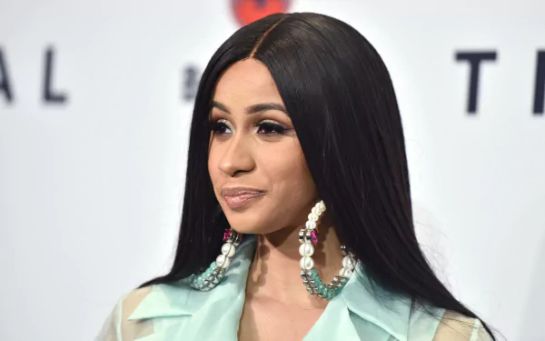 Close-up of Cardi B, showcasing her stylish look with long, straight hair and statement earrings, serving as a vibrant HD desktop wallpaper and background for music lovers.