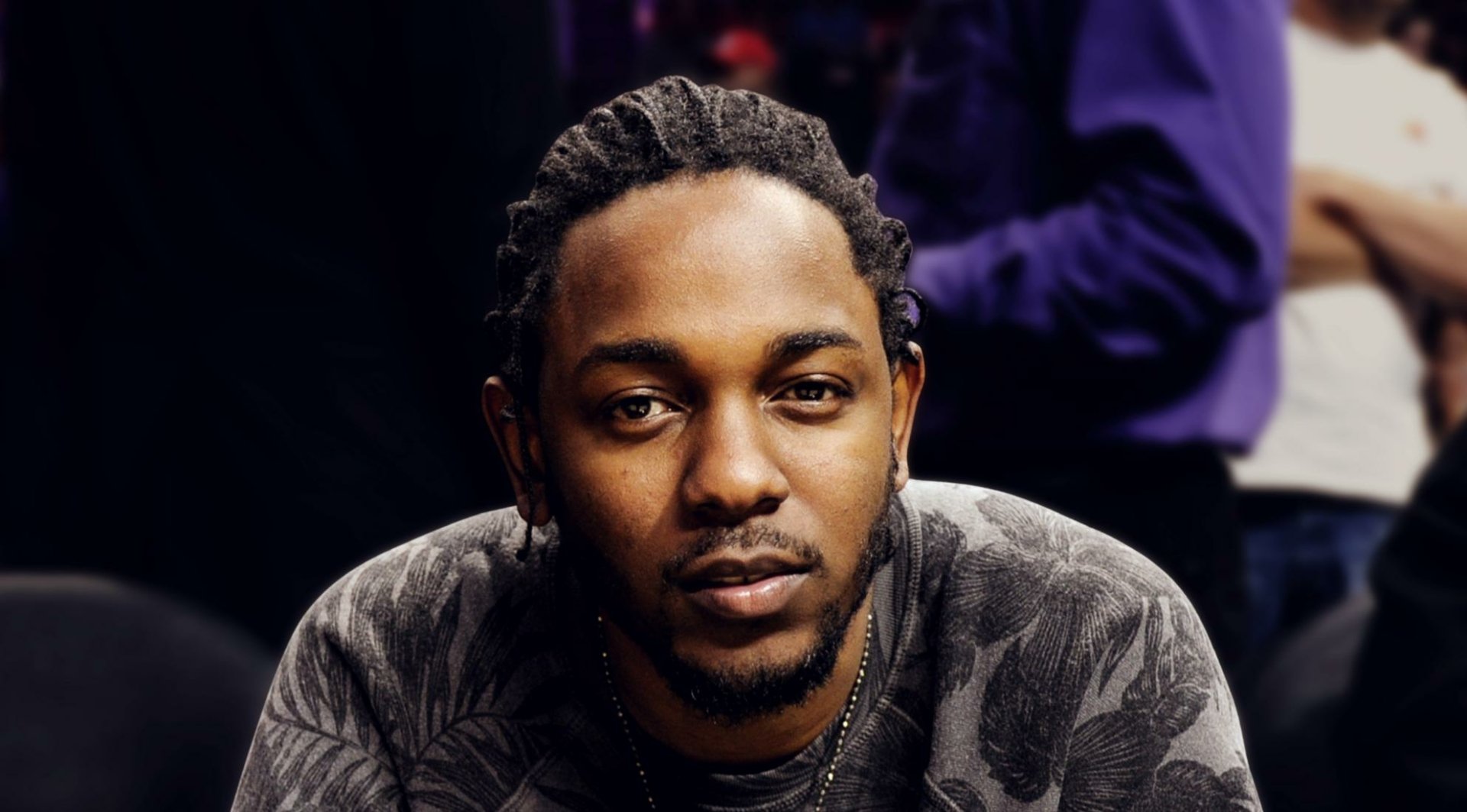 HD desktop wallpaper featuring a focused portrait of Kendrick Lamar against a blurred background.