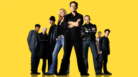 HD PC desktop wallpaper: ensemble cast from The Italian Job (2003) posed together against a bold yellow background.