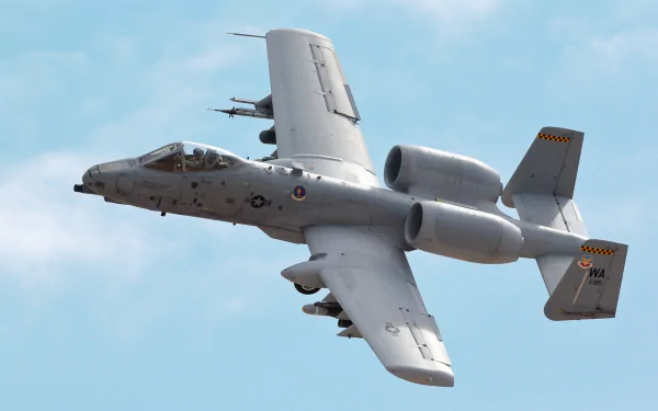 HD desktop wallpaper featuring a Fairchild Republic A-10 Thunderbolt II military warplane in flight against a clear blue sky.