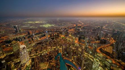 A stunning HD desktop wallpaper showcasing Dubai’s vibrant cityscape and skyline at sunset, featuring iconic man-made buildings against a glowing horizon.