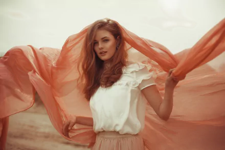 HD desktop wallpaper featuring a redhead woman model in a flowing white blouse with a peach-colored translucent scarf blowing in the wind.