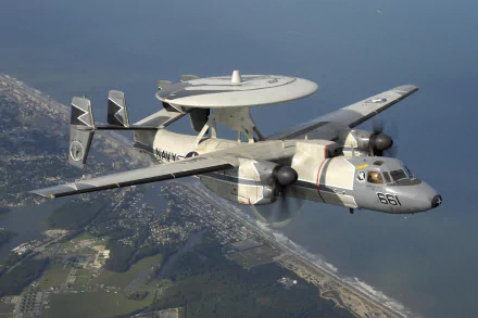 Northrop Grumman E-2 Hawkeye military warplane in flight over coastline, captured in stunning 4K Ultra HD for PC desktop wallpaper and background.