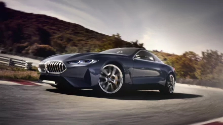 5K Ultra HD wallpaper of a BMW Concept 8 Series vehicle, a sleek blue BMW 8 Series concept car driving on a mountain road.