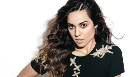 HD desktop wallpaper of American actress Summer Bishil with long brunette hair and brown eyes, wearing a black top adorned with decorative starfish patterns.