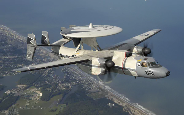 Northrop Grumman E-2 Hawkeye military warplane in flight over coastline, captured in stunning 4K Ultra HD for PC desktop wallpaper and background.
