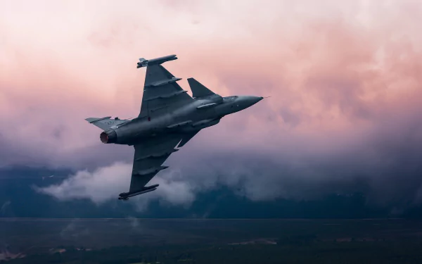 Saab JAS 39 Gripen military aircraft and jet fighter warplane soaring through dramatic pink-and-gray clouds — HD desktop wallpaper background.